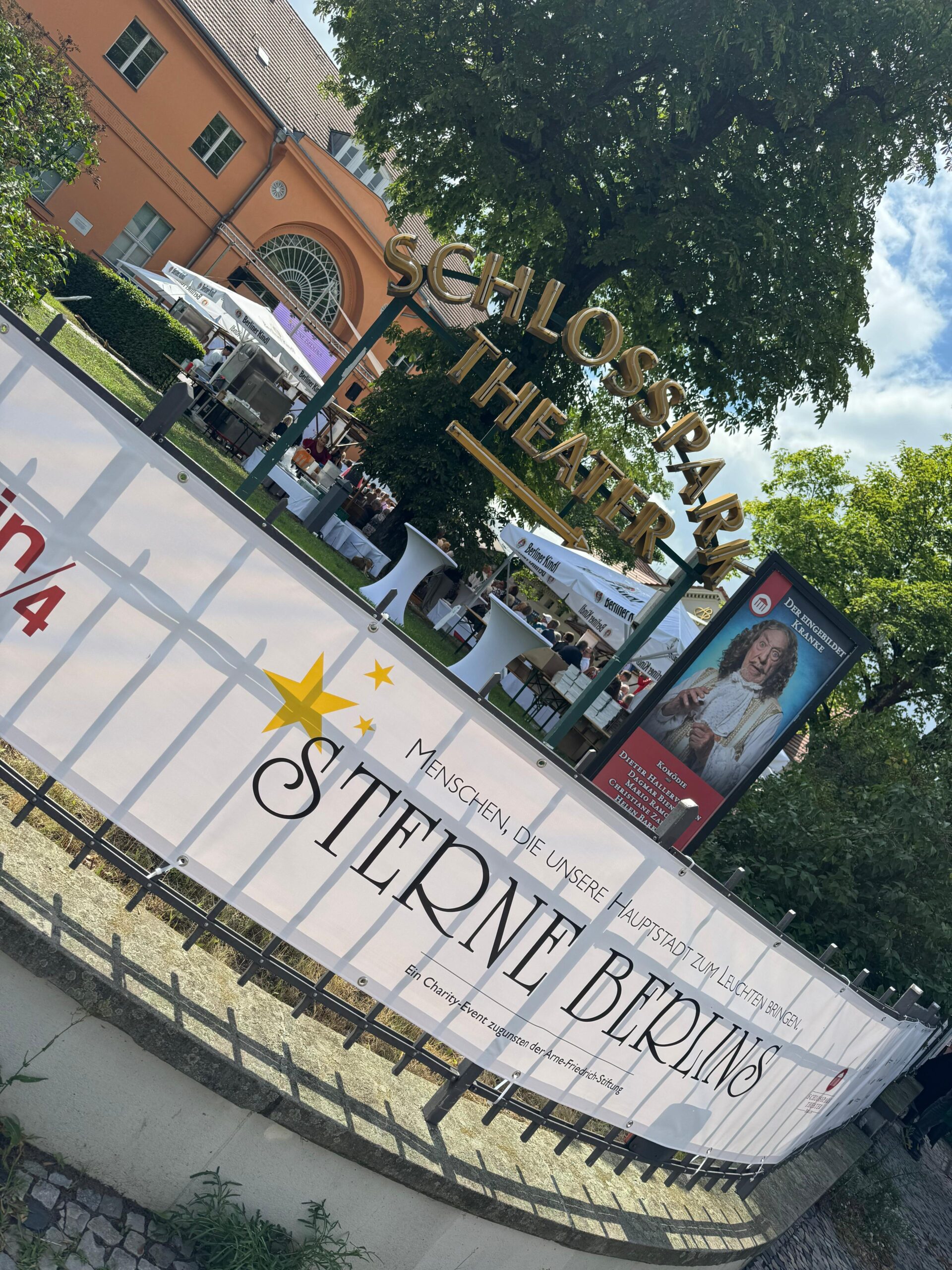 Banner des Sommerfests Sterne Berlins vor dem Schlosspark Theater mit Blick auf das Festgelände